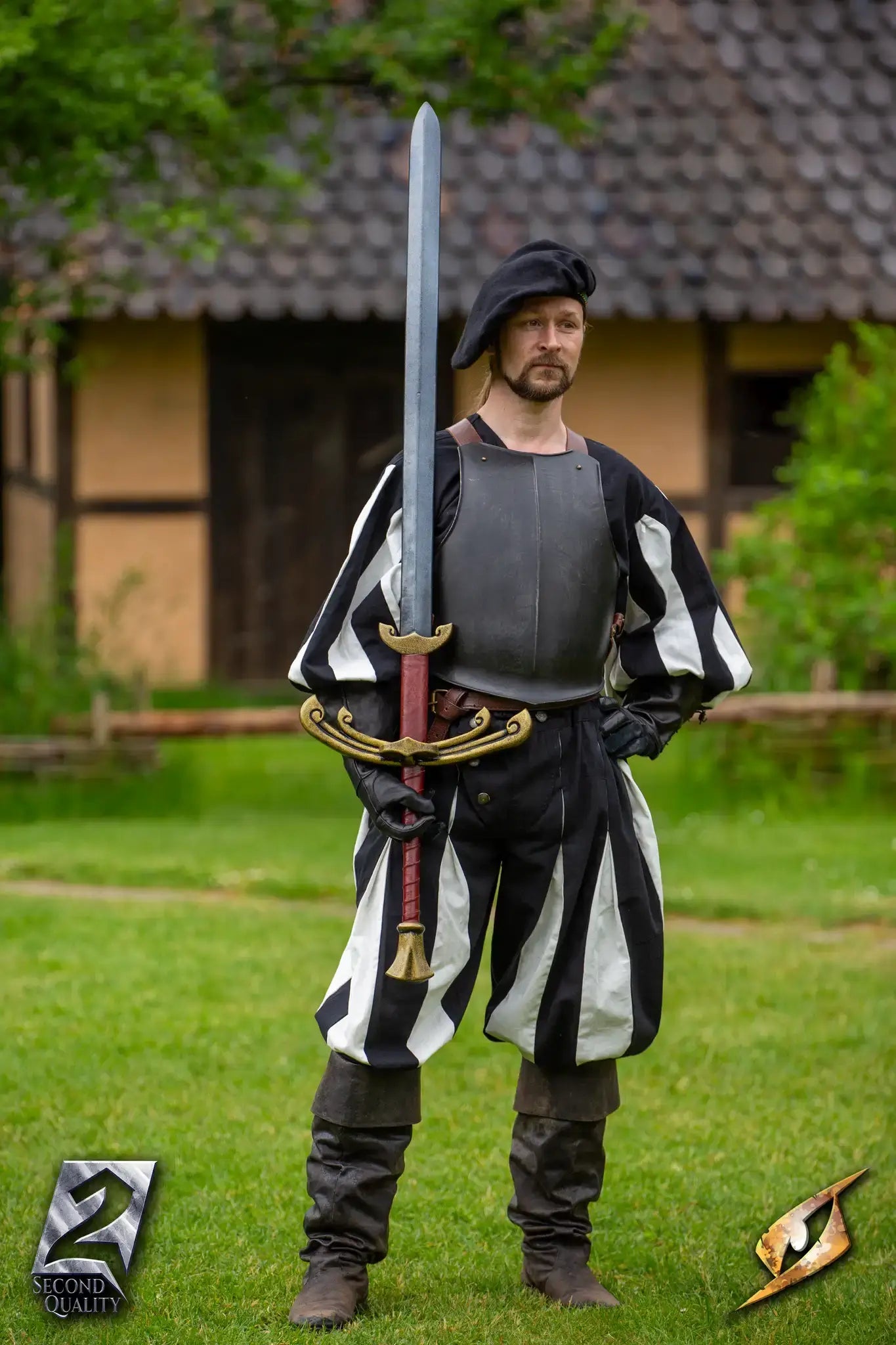 2nd Quality – Landsknecht Greatsword displayed by a man in Renaissance attire, showcasing its impressive length and design.