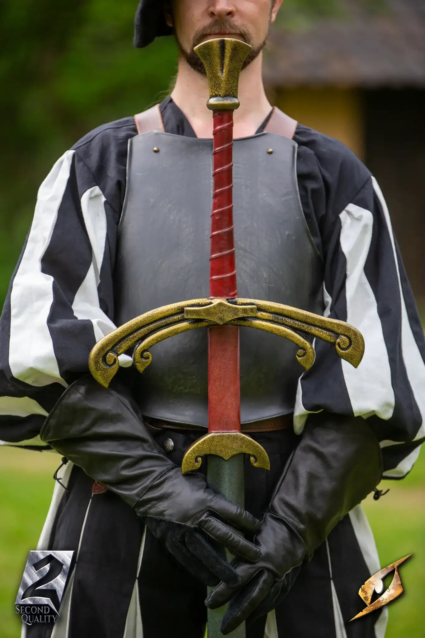 2nd Quality – Landsknecht Greatsword displayed by a man in historical attire, featuring a gold crossguard and red grip.