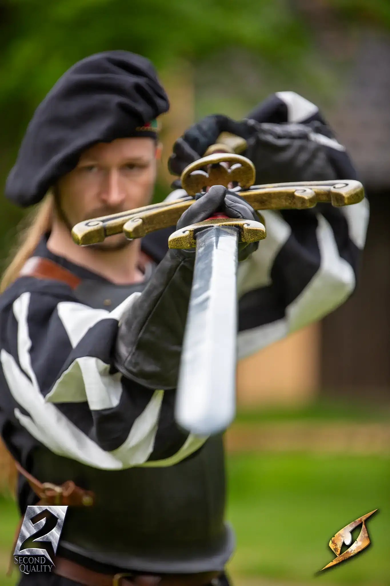 2nd Quality – Landsknecht Greatsword held by a warrior in Renaissance attire, showcasing its broad blade and detailed crossguard.