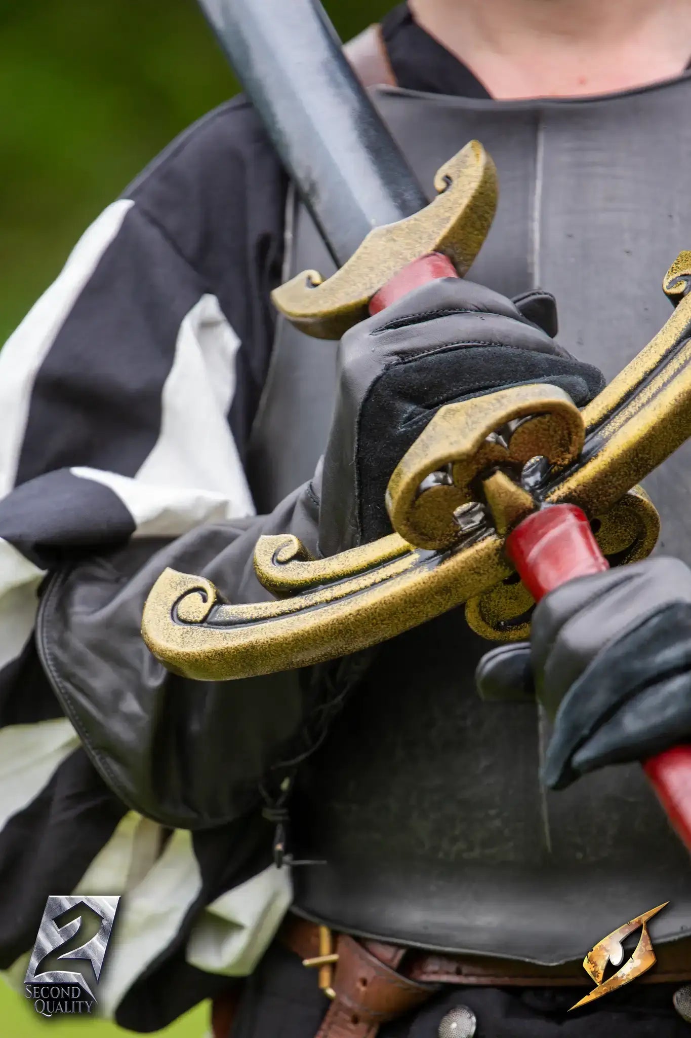 2nd Quality – Landsknecht Greatsword held by a fighter in historic attire, showcasing its ornate crossguard and grip.