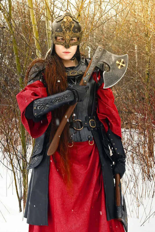 Baruk II axe held by a warrior in a red cloak with a helmet in a snowy forest setting.