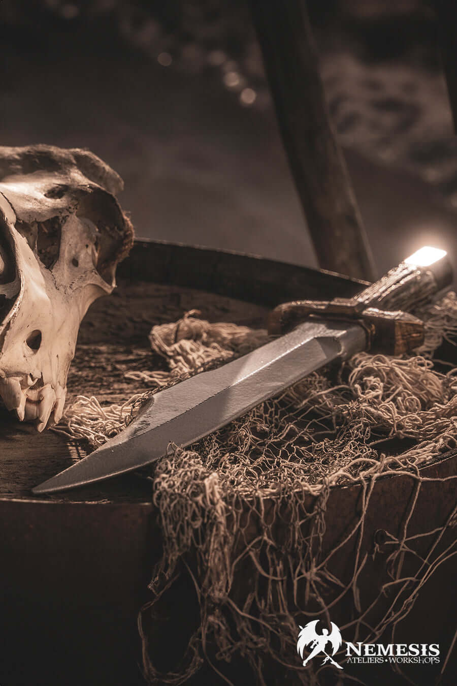 Bowie knife resting on a textured surface next to a skull and netting, evoking a sense of adventure.
