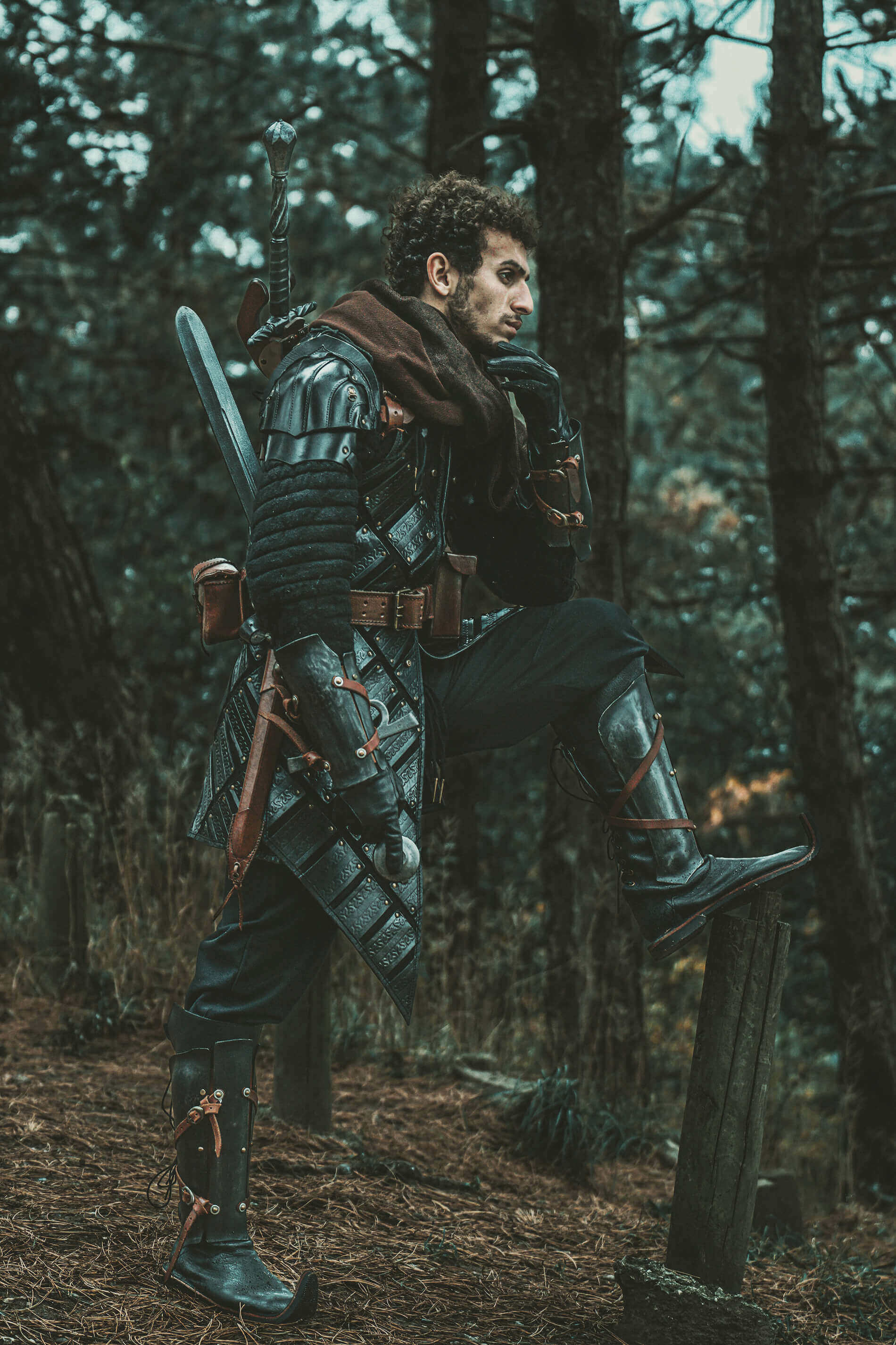 Person in witcher style leather armor, standing in the forest