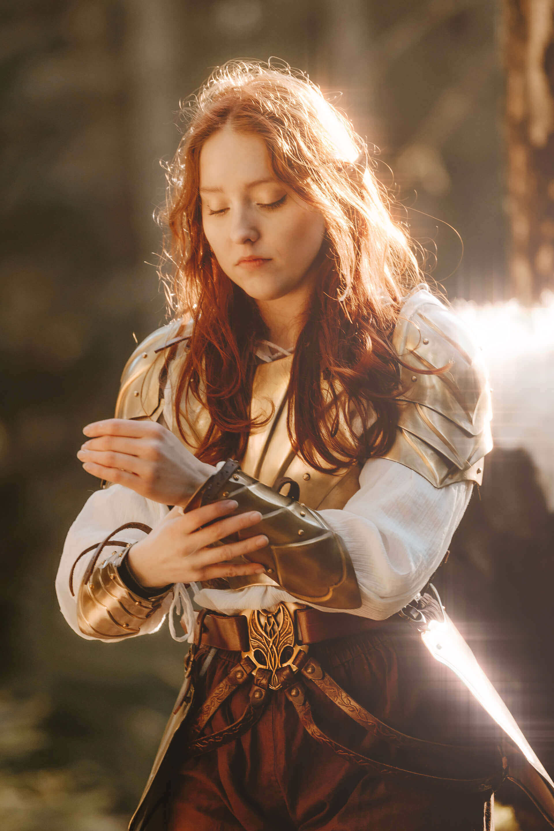 Person in golden elven inspired armor, with the sun against their back.