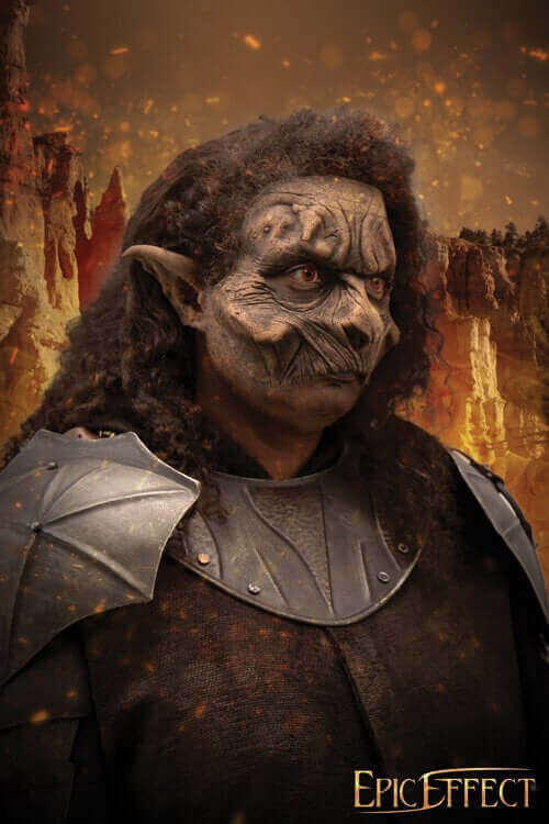 Fantasy character with detailed face makeup, wearing armor, against a scenic fiery background.