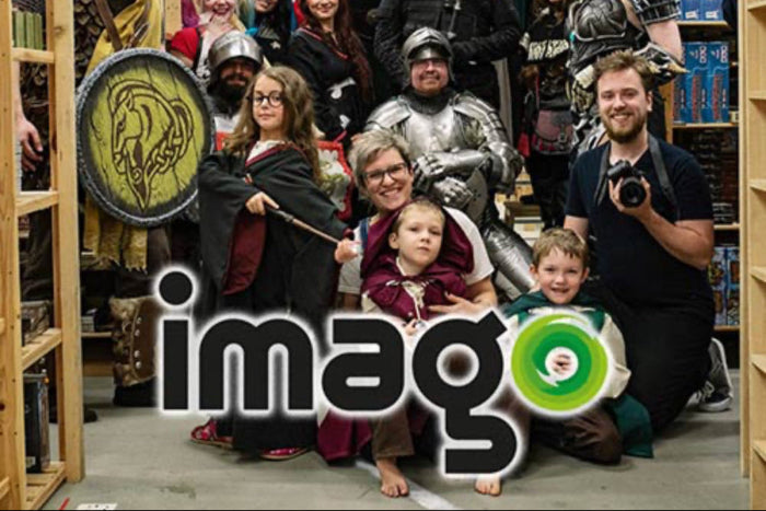A lively group of cosplayers and friends gathering at a gaming event with the 'imago' logo prominently featured.