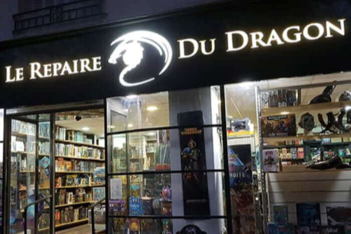 Storefront of Le Repaire Du Dragon, showcasing a variety of board games and collectibles.