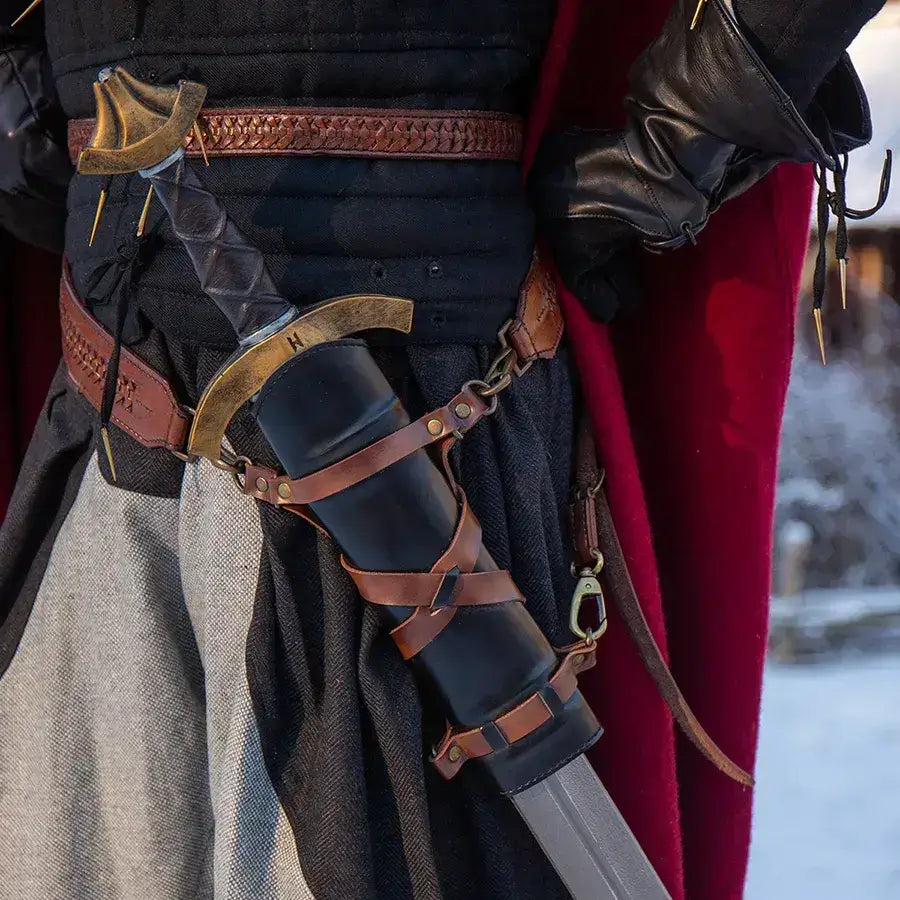 Close-up of a knight's sword in a leather scabbard, worn at the waist, showcasing detailed craftsmanship and medieval attire.