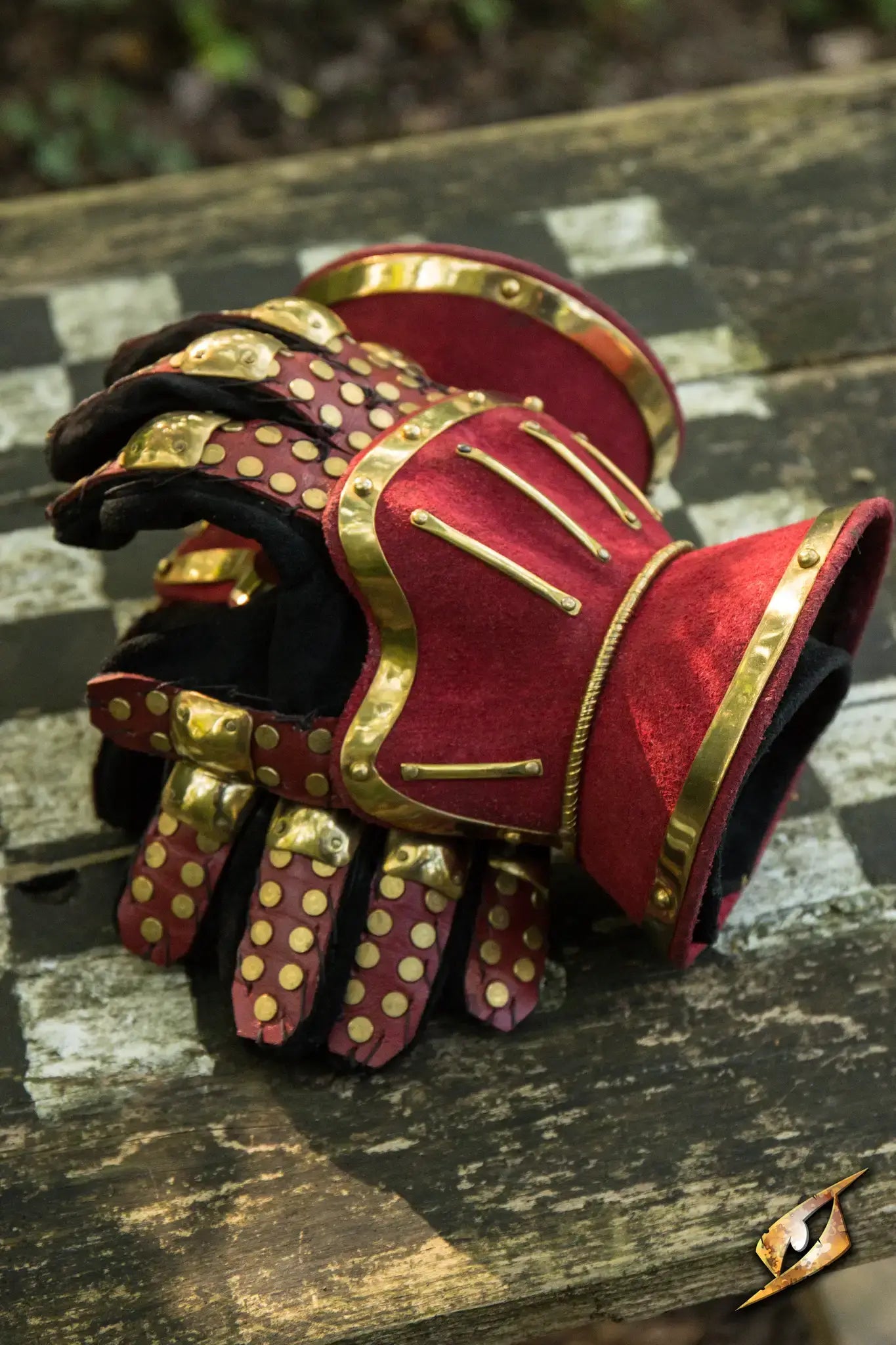 Gauntlets featuring a red and gold design, providing protection and dexterity for combat.