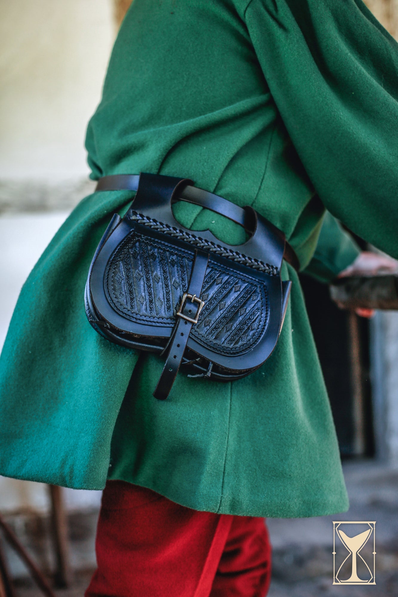 Medieval black leather bag worn on a green coat, perfect for style and practicality in Bags & Purses collection.