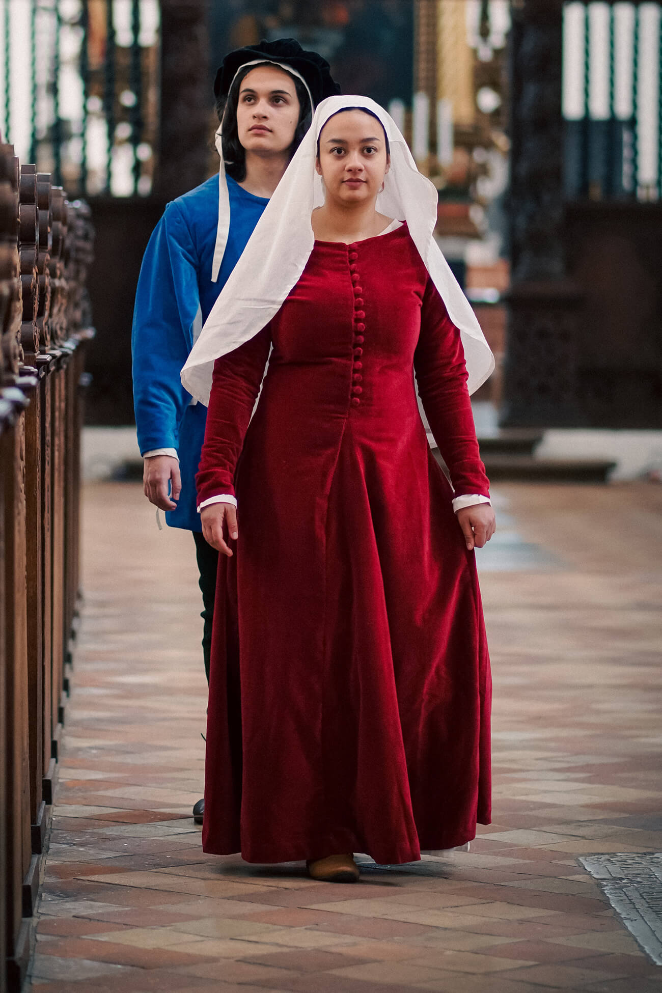 A woman and a man wearing late medieval clothing