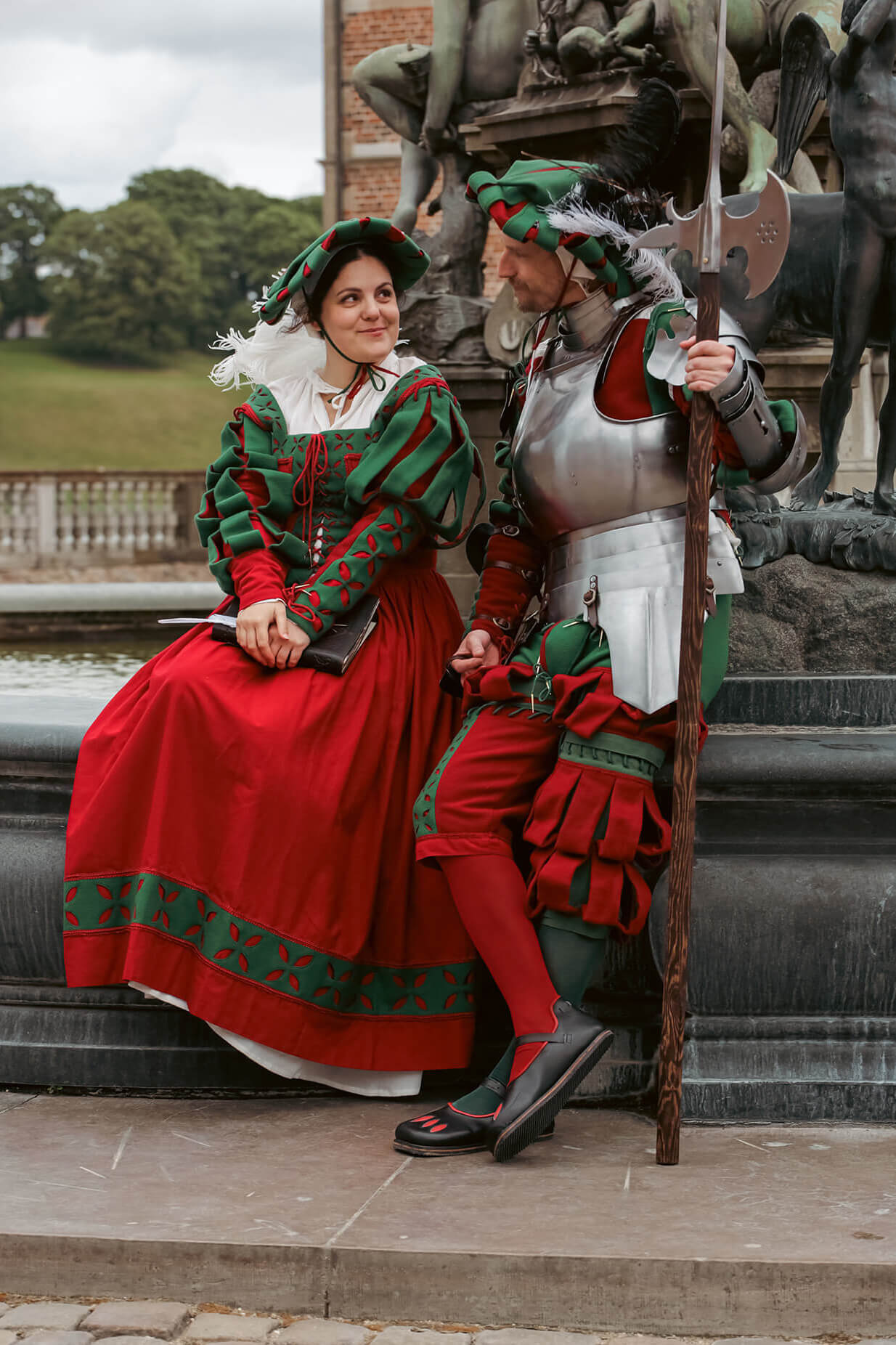 a woman and a man wearing renaissance landsknecht clothing