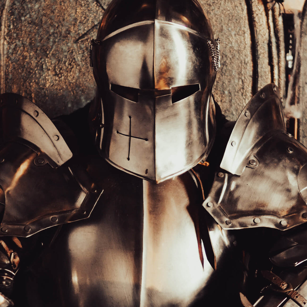 A close-up of a knight in shining Medieval Armour, showcasing detailed metal craftsmanship and design.