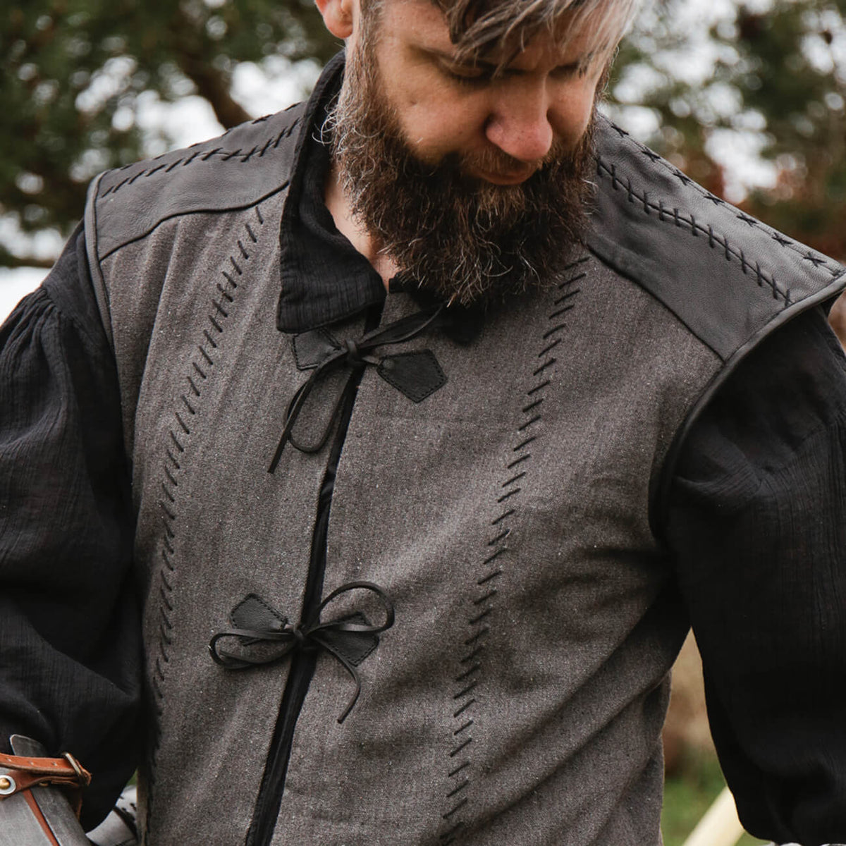 Medieval Clothing showcasing a bearded man in a historical garment with intricate details and practical design.