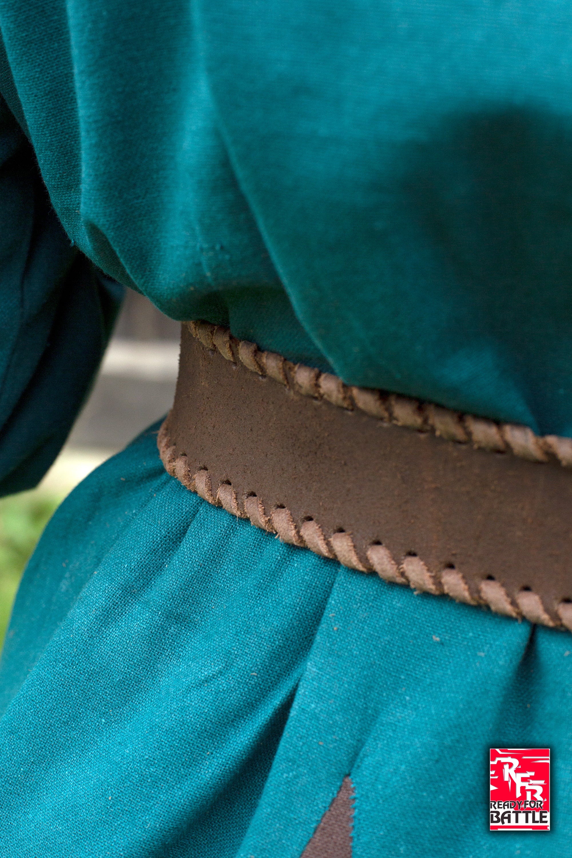 RFB Laced Belt featuring a braided design worn with a green tunic for historical reenactments.
