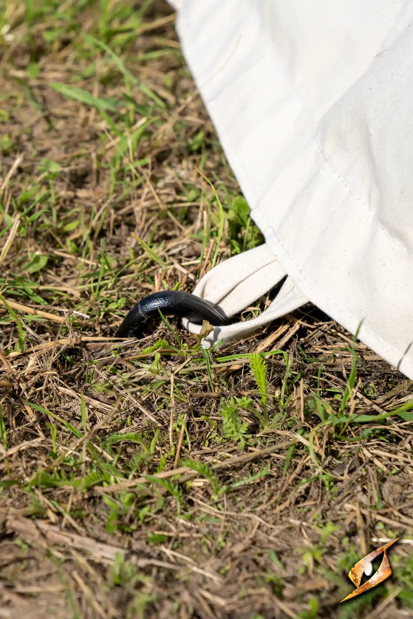 Marquee Tent - 4x6m ground stake securing the tent on grassy surface during an outdoor event.