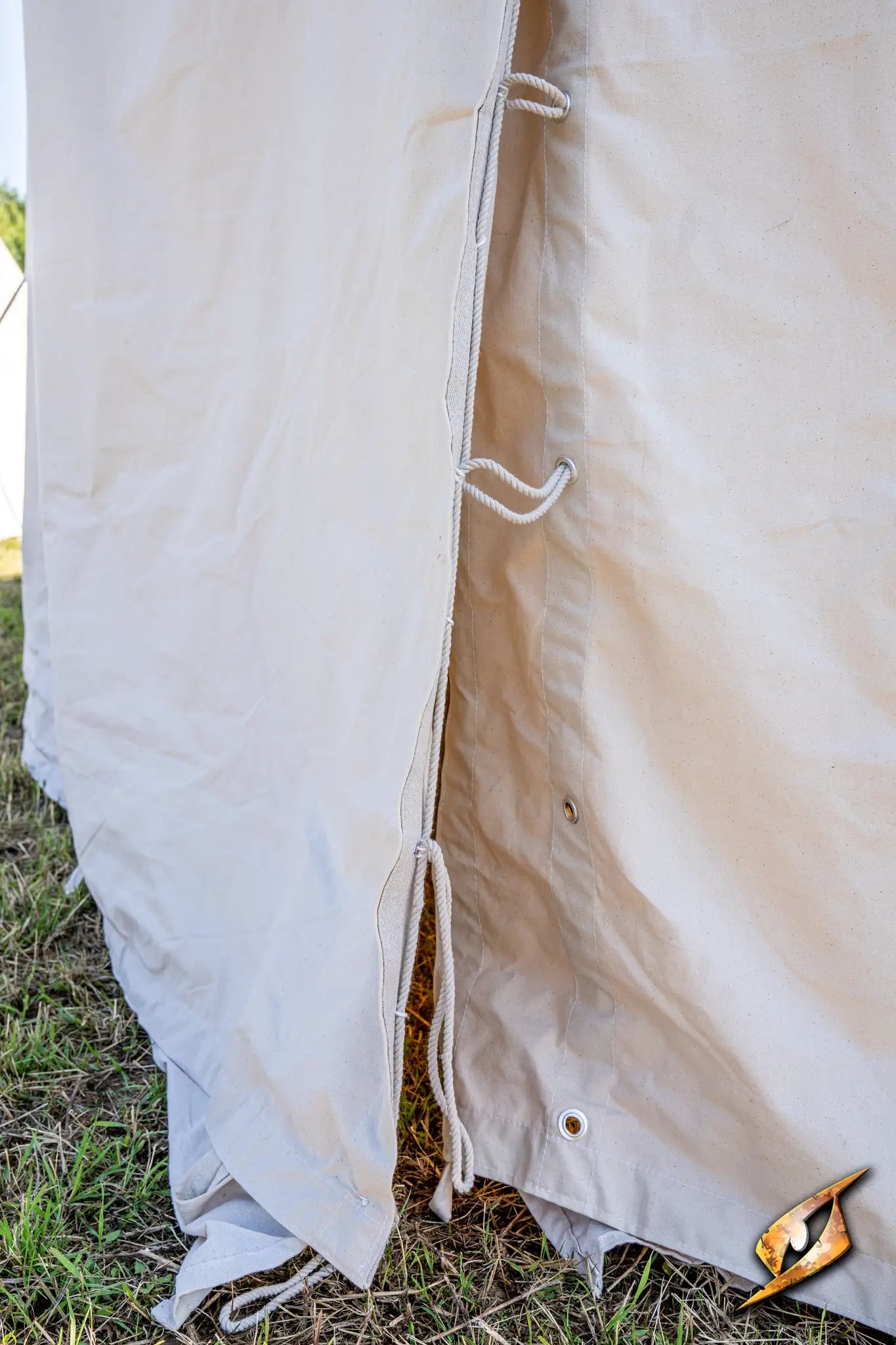 Close-up of the side of a Marquee Tent - 4x6m with tied fabric and metal grommets.