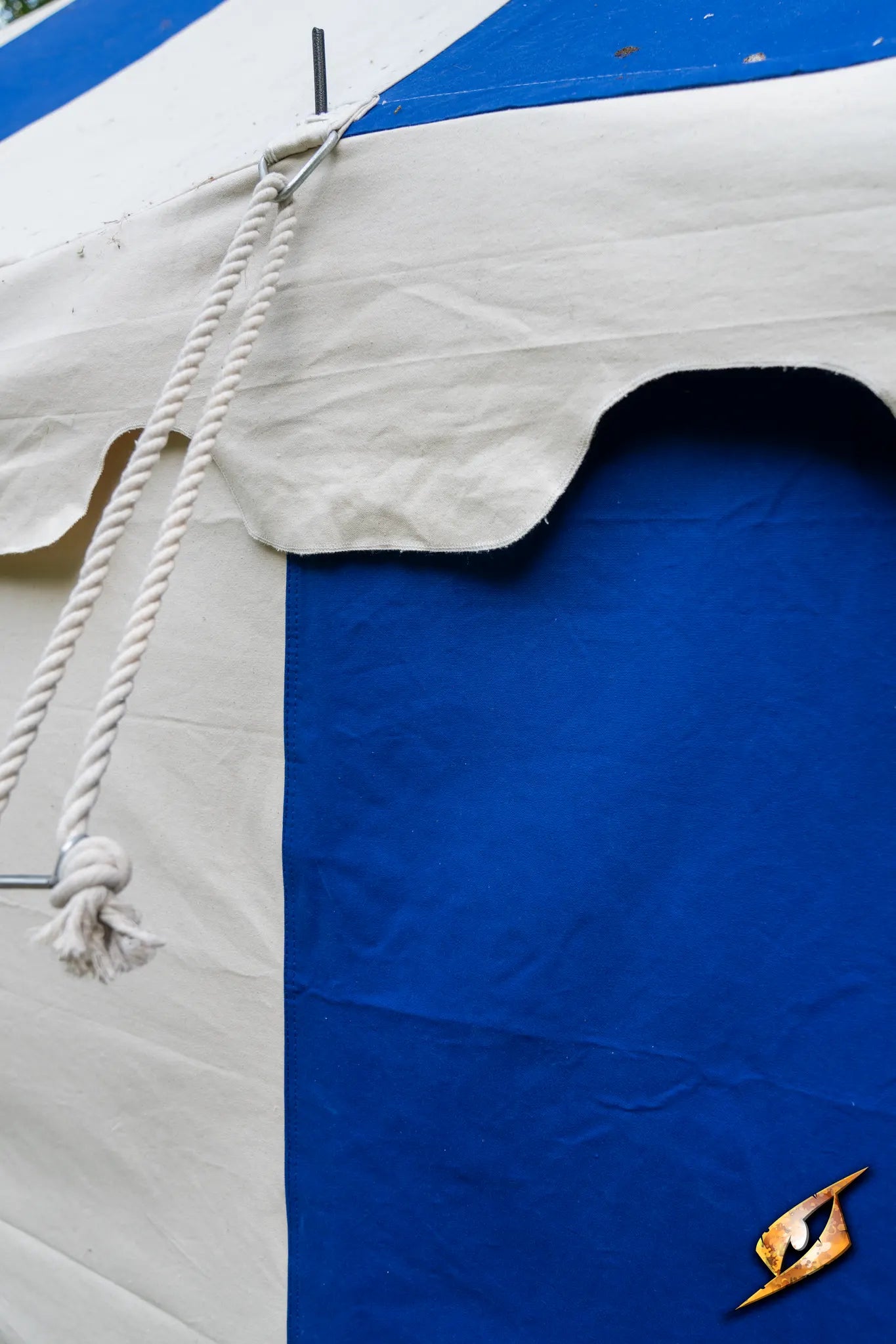 Marquee Tent - 4x6m featuring blue and white fabric, ropes, and a decorative emblem.