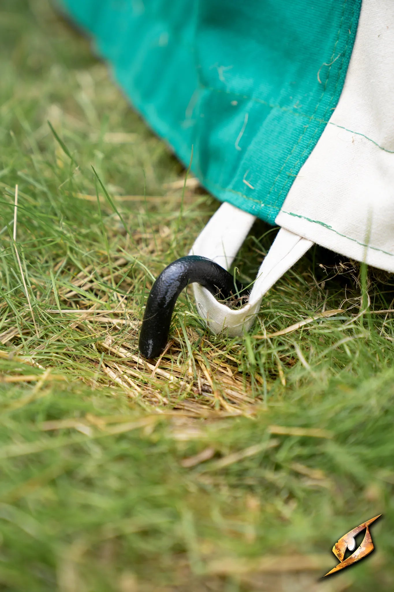 Marquee Tent - 4x6m stake securing the side of the tent to the grass, ensuring stability during outdoor events.