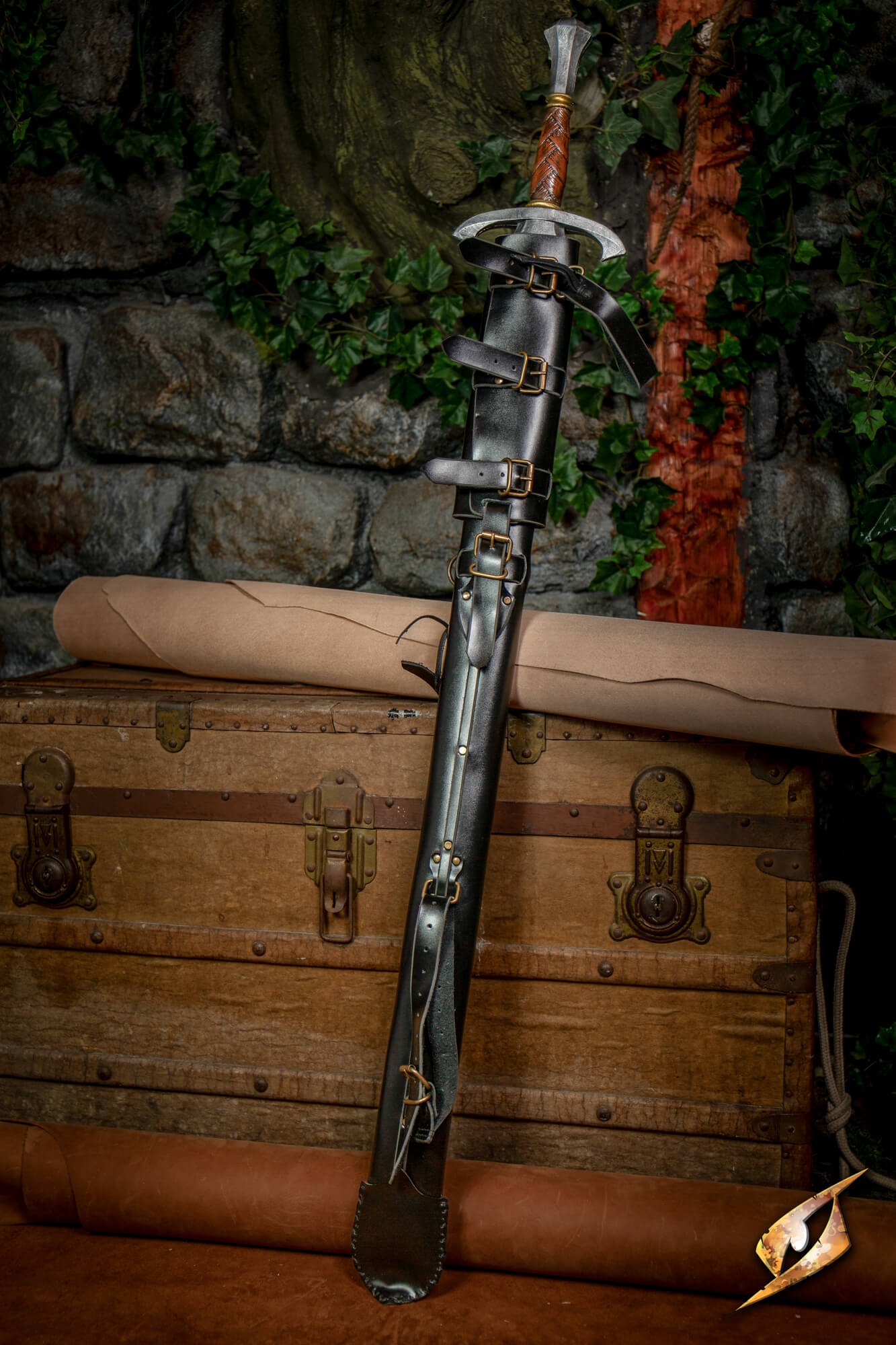 Adjustable Scabbard - Faux Leather displayed with a sword resting on a wooden chest.