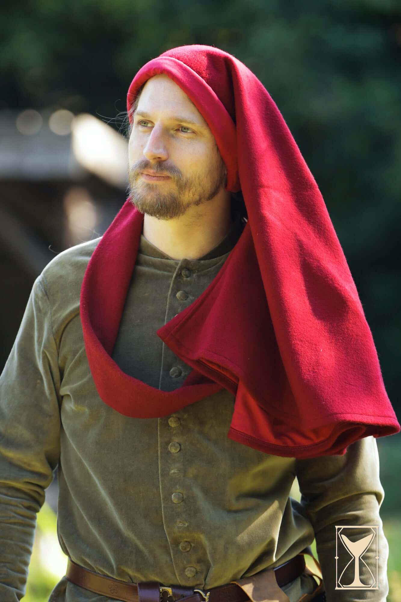 Simple Liripipe Hood - Brushed Wool worn by a man in a medieval setting, showcasing its practical design and warmth.