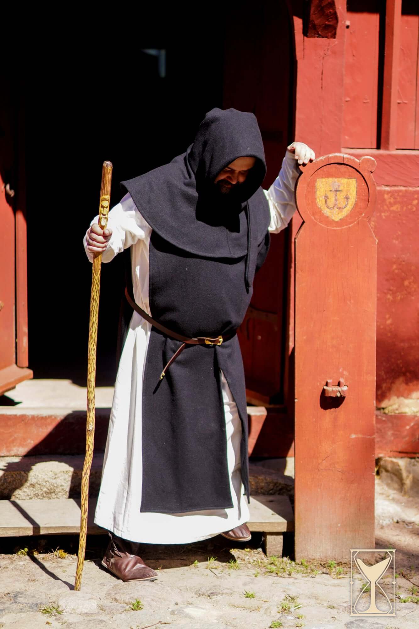 Simple Liripipe Hood - Brushed Wool worn by a person with a wooden staff, medieval outdoor setting.