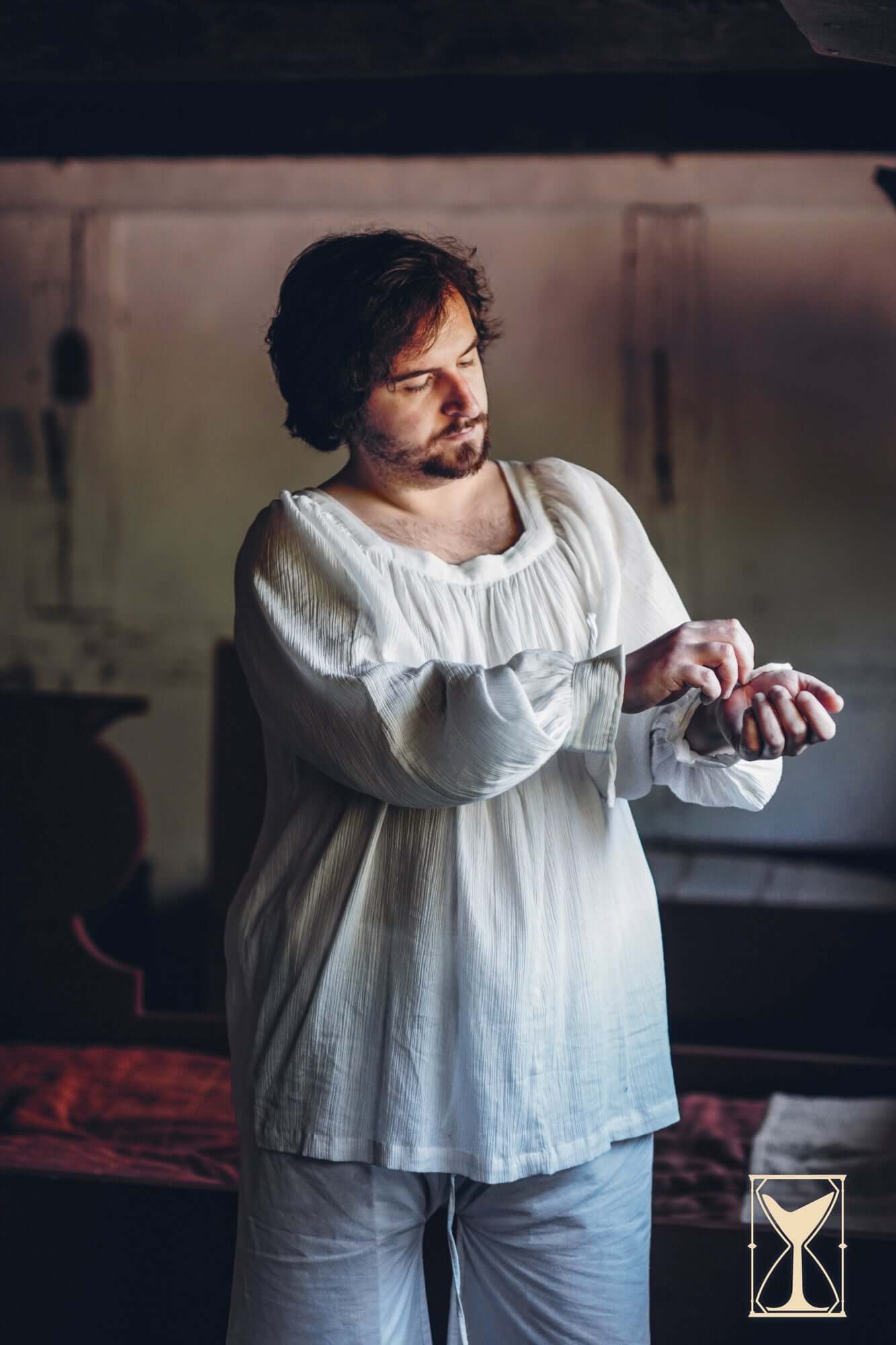 Man wearing Shirt Duccio in a medieval-inspired setting, showcasing historical fashion.