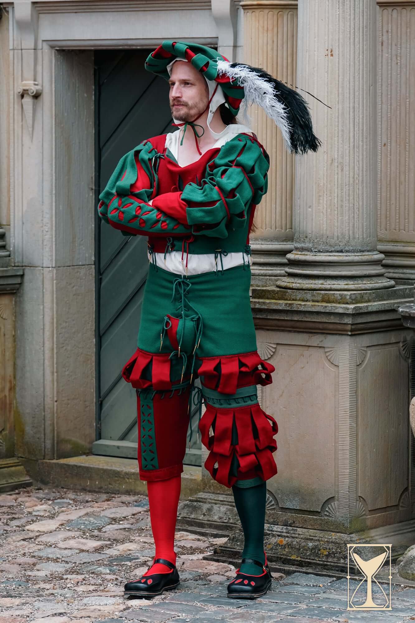 Landsknecht Waterfall Sleeve showcased on a model in 16th-century inspired ensemble with bold colors and slashed design.