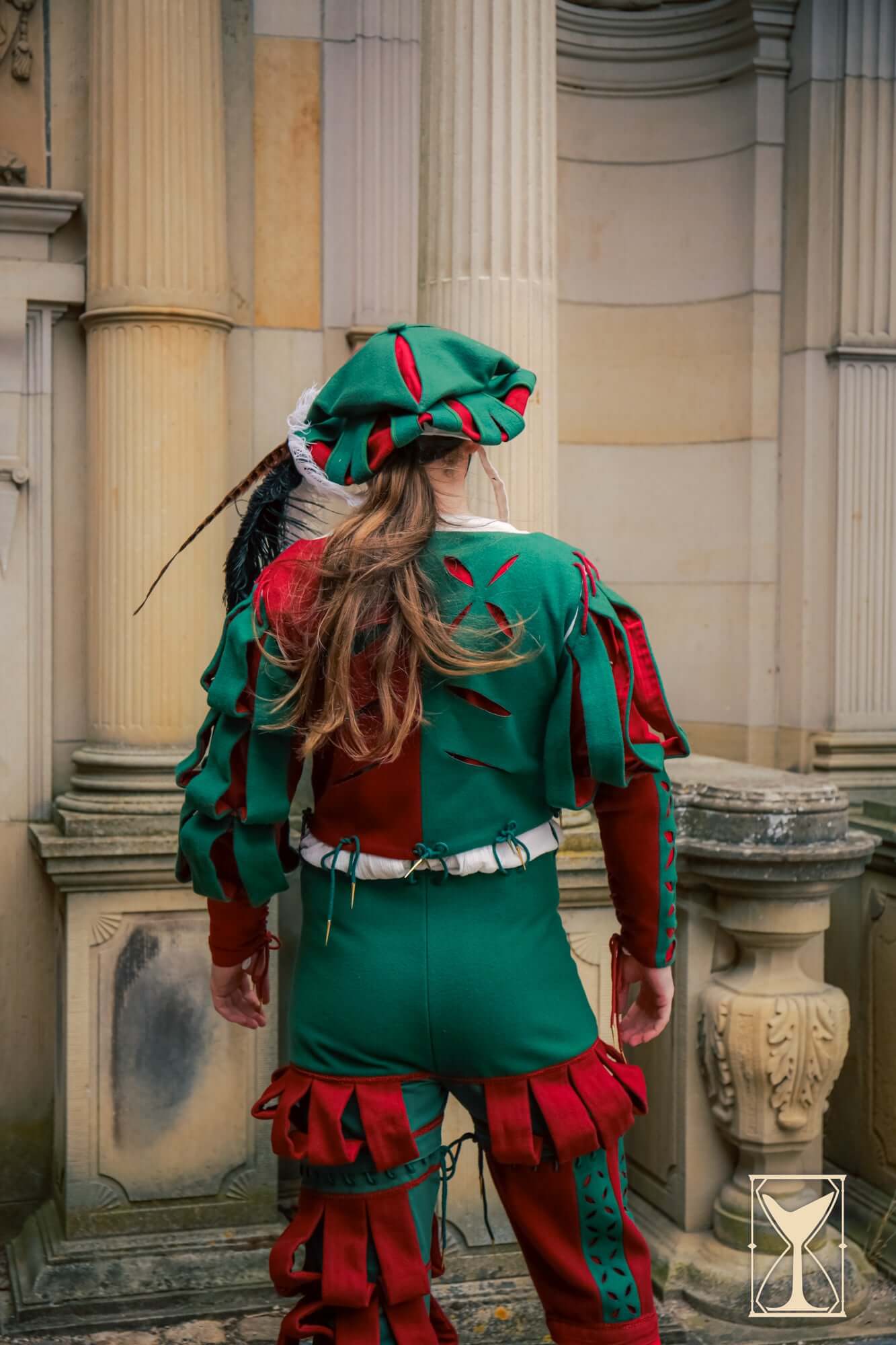 Back view of a person wearing vibrant red and green Landsknecht Breeches, showcasing Renaissance fashion style.