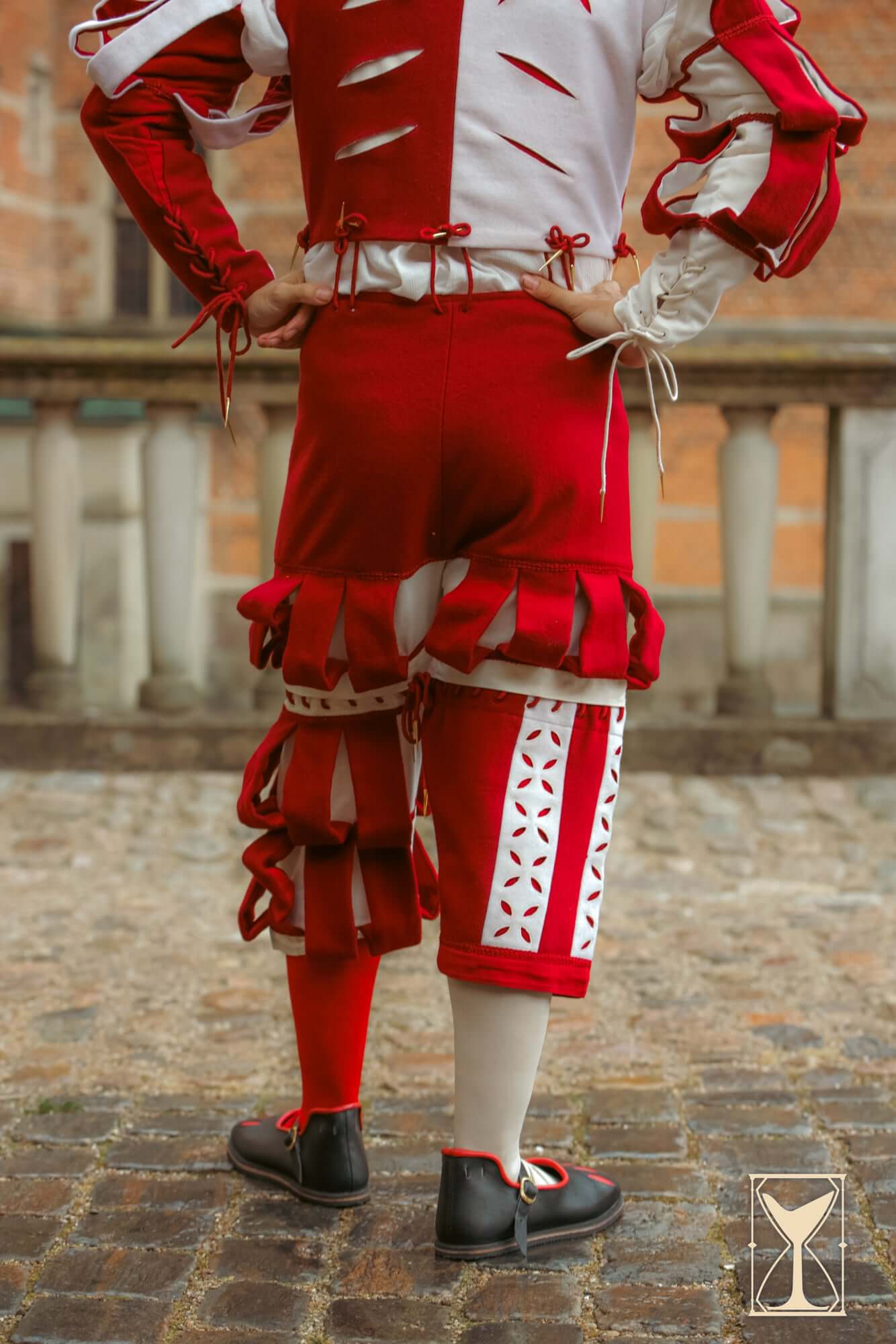 Landsknecht Breeches showcasing a bold red and white design with slashing details and ruffled embellishments.