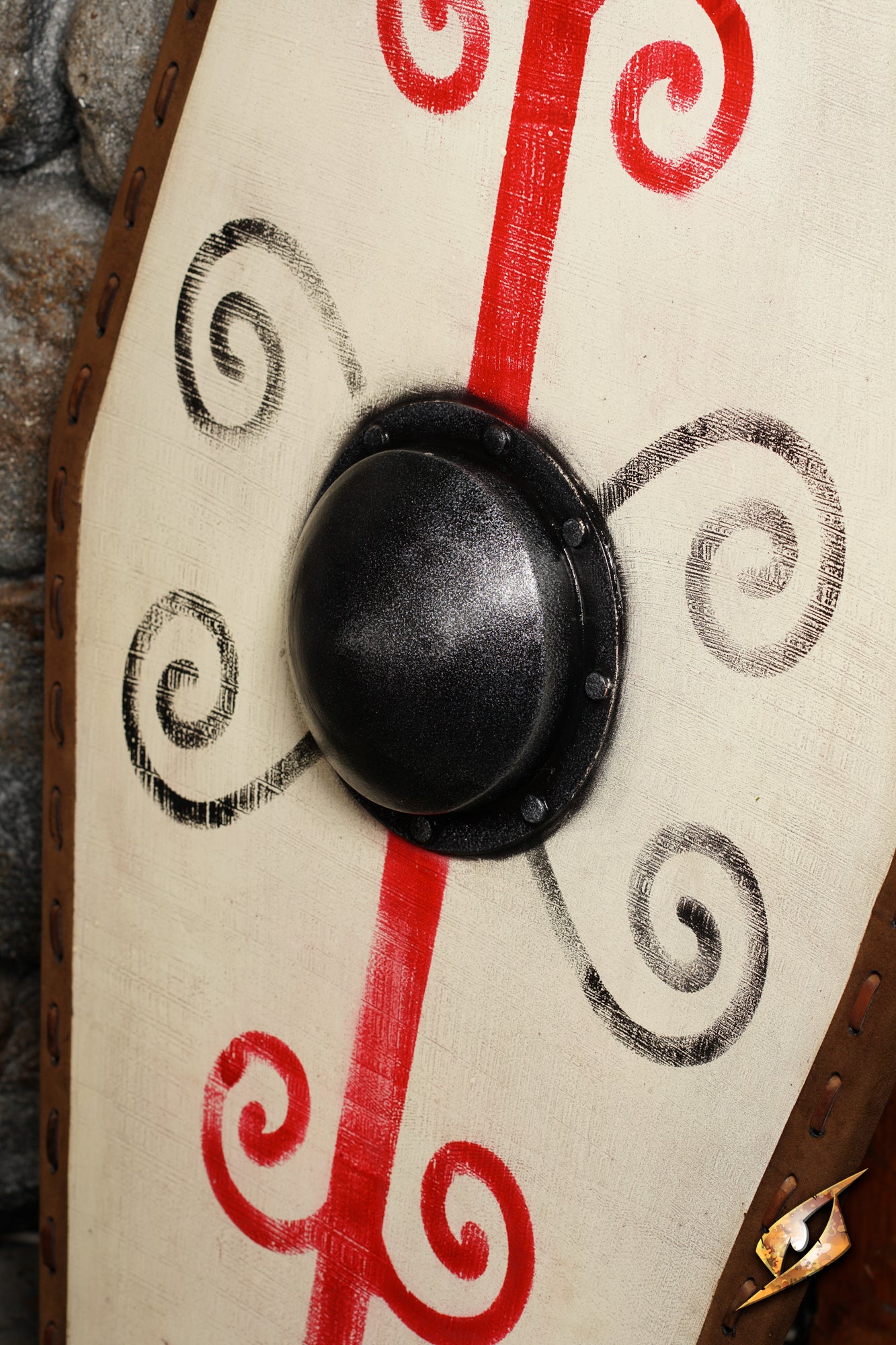 Close-up of Germanic Shield featuring red markings, a black boss, and brown leather edge.