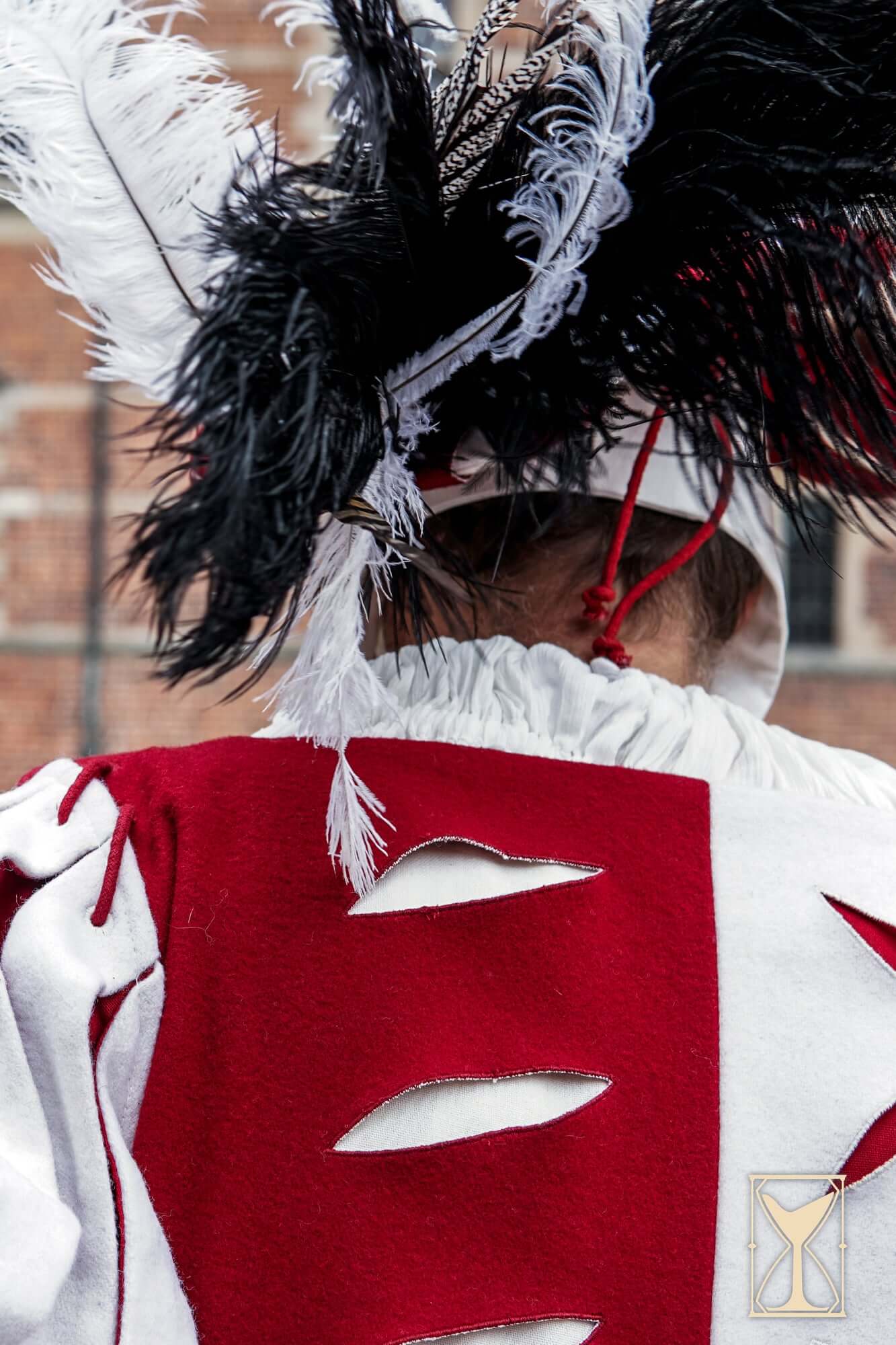 Landsknecht Doublet featuring puff and slash design and bold feathered hat in historical reenactment setting.