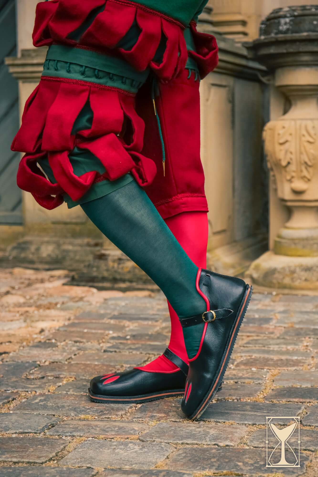 Rich Landsknecht Shoes worn with colorful Renaissance attire, showcasing the iconic slashed design.