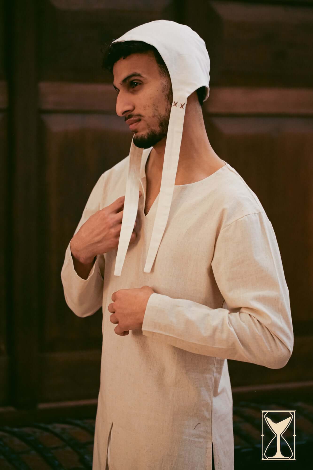 Medieval Riding Tunic worn by a model, showcasing its design and deep splits for movement.
