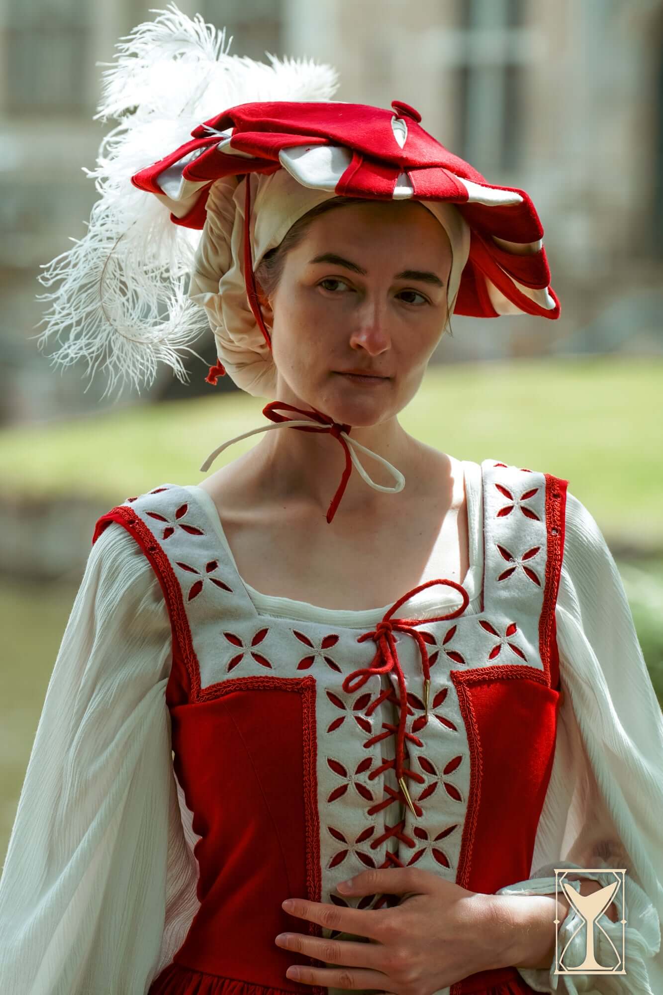 Landsknecht Hat worn by a woman in a Renaissance costume with detailed embroidery and vibrant colors.