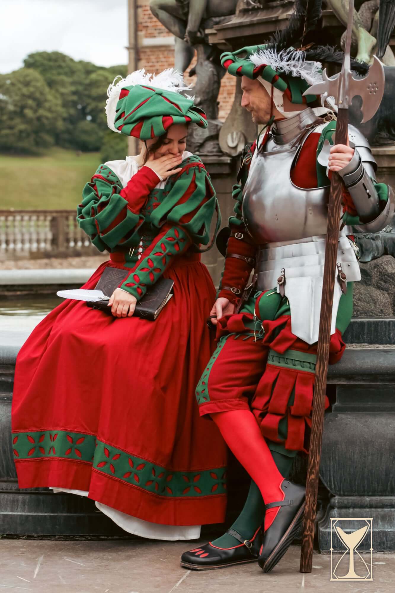 Landsknecht Hat worn by couple in vibrant historical costumes, showcasing 16th-century design and style.