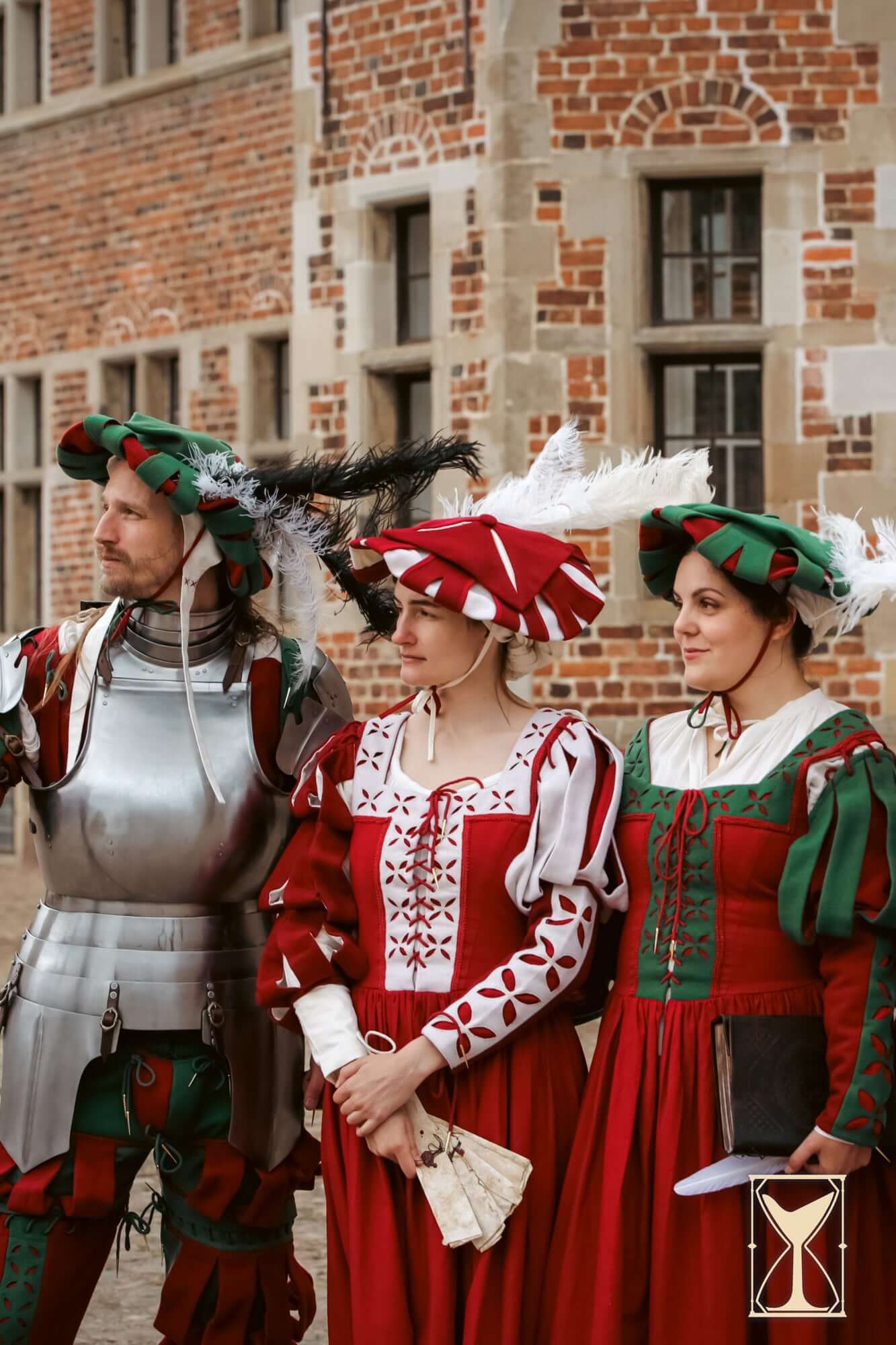 Landsknecht Hat worn by three individuals in colorful Renaissance attire, showcasing 16th-century fashion.