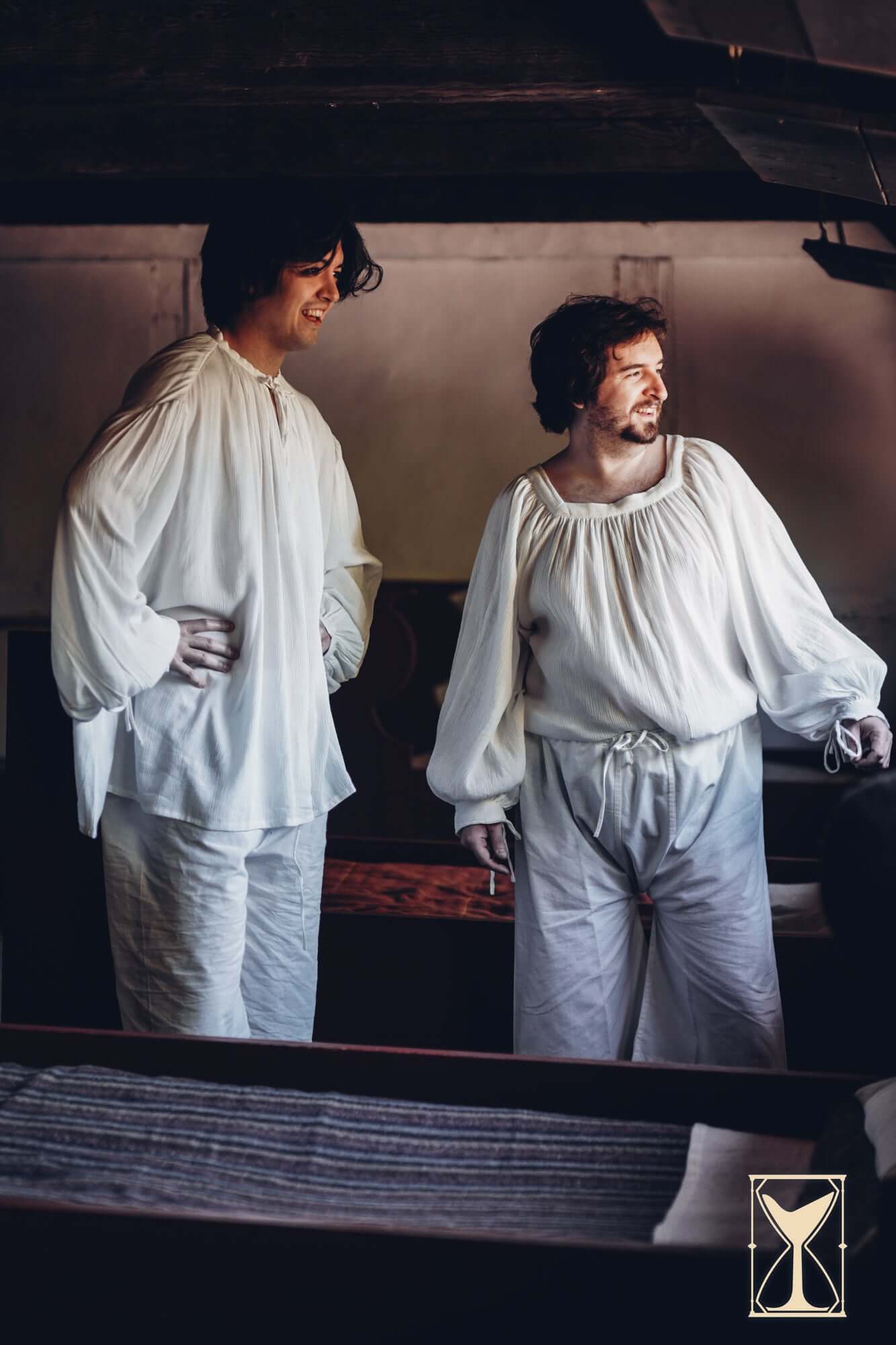 Two men wearing historical medieval Braies - Long in a cozy indoor setting.