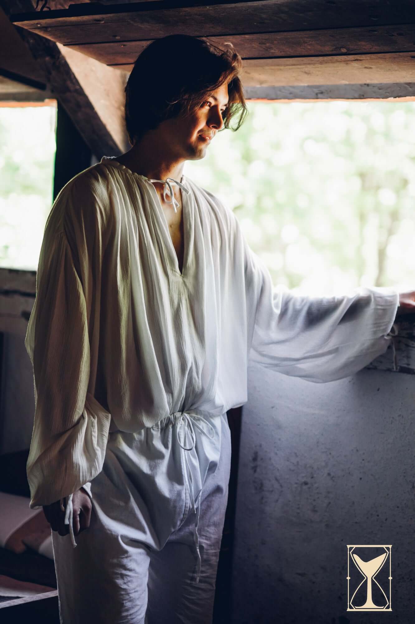 Braies - Long worn by a person standing by a window in a rustic setting, ideal for medieval outfits.