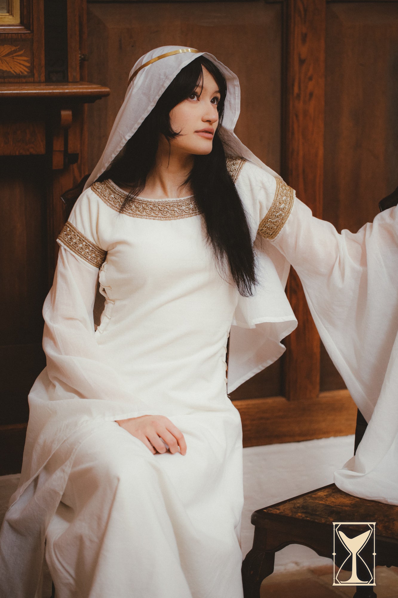 Elegant model wearing the Bliaut Noble dress, showcasing its flowing design and luxurious fabrics.