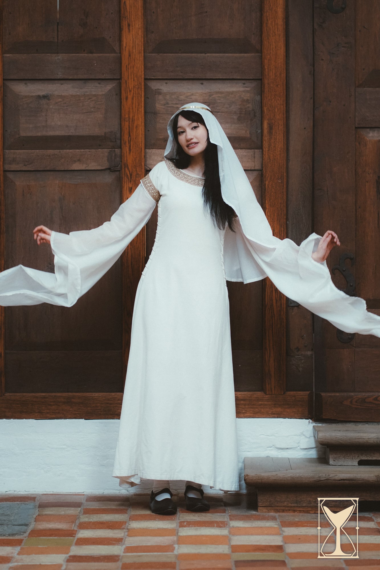 Model wearing a Bliaut Noble dress showcasing flowing sleeves and elegant design.