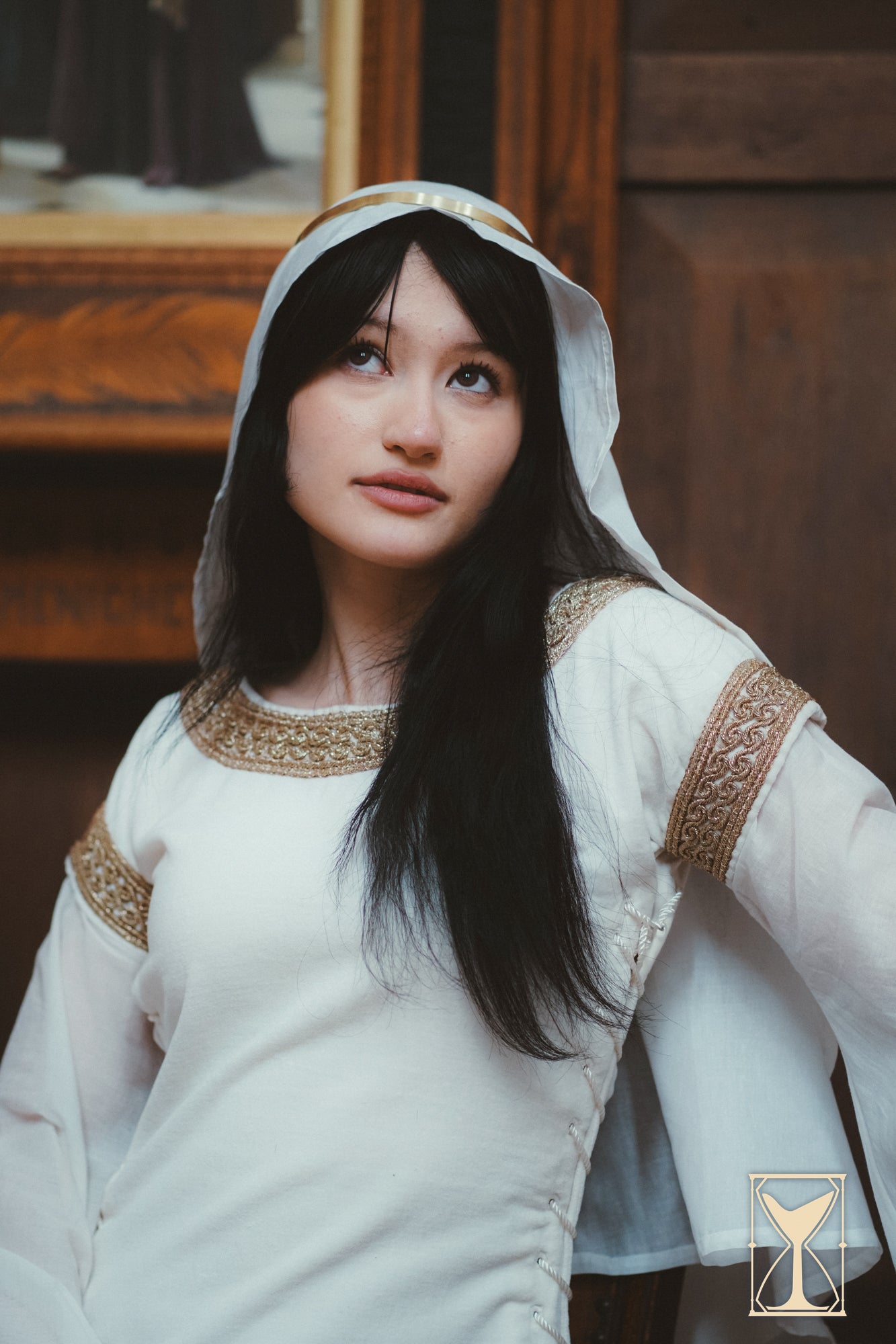 Model wearing a Bliaut Noble dress, showcasing its elegant design and flowing sleeves.
