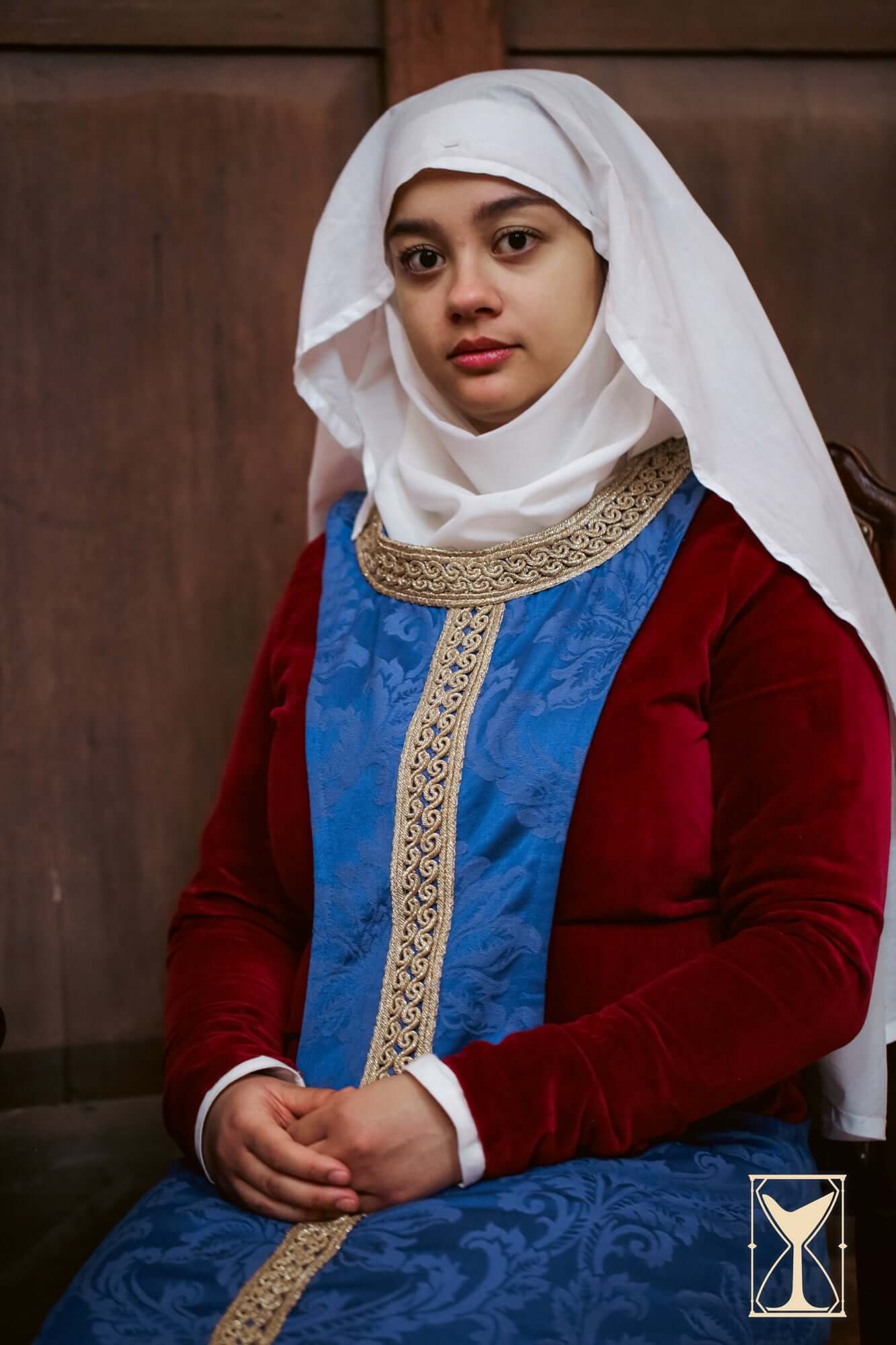 Pellote - Medieval Dress styled with luxurious brocade fabric and traditional headwear, representing 14th-century fashion.