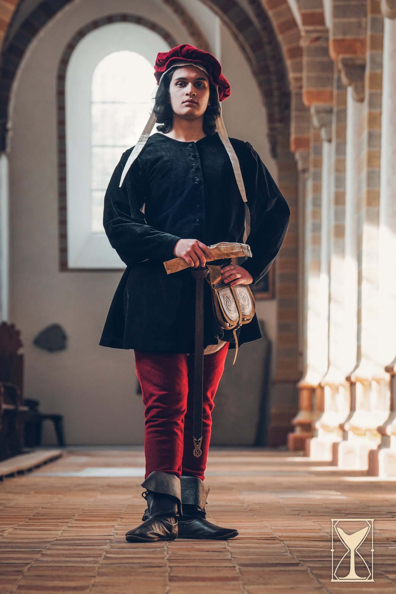 Velvet Surcoat worn by a model in a medieval setting, showcasing its versatile and rich design.