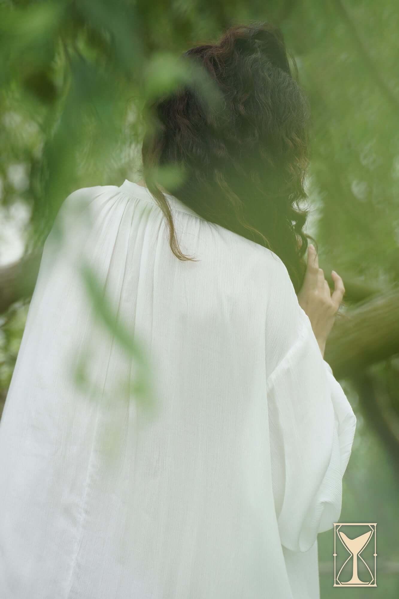 Model wearing Smock Violet under soft natural light, showcasing the loose-fitting design and elegant flow.