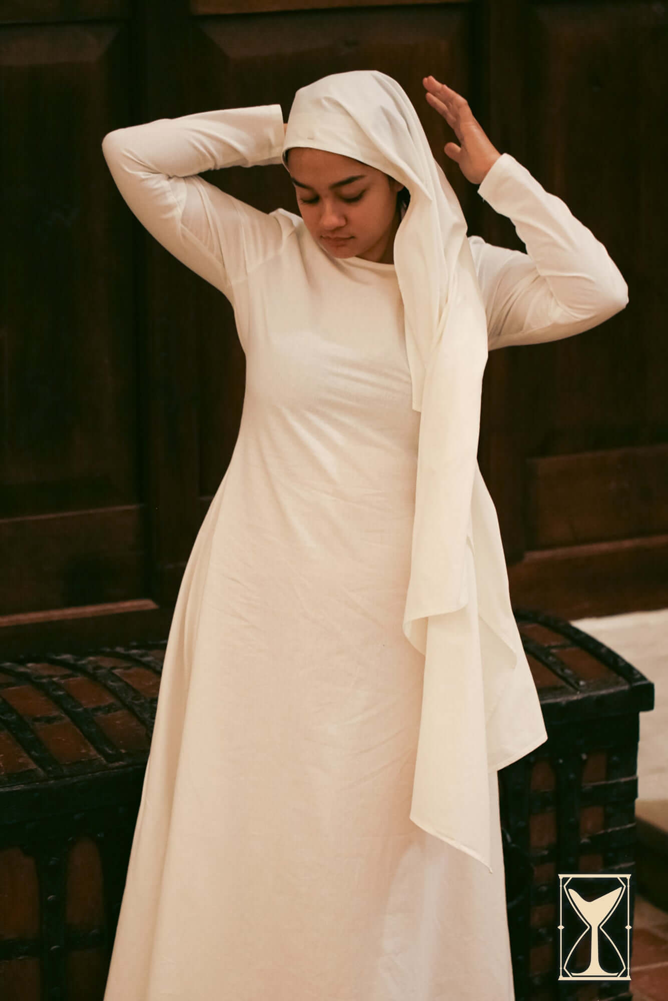 Young woman wearing a Rectangular Veil and Fillet - Cotton, styled elegantly with a long dress.