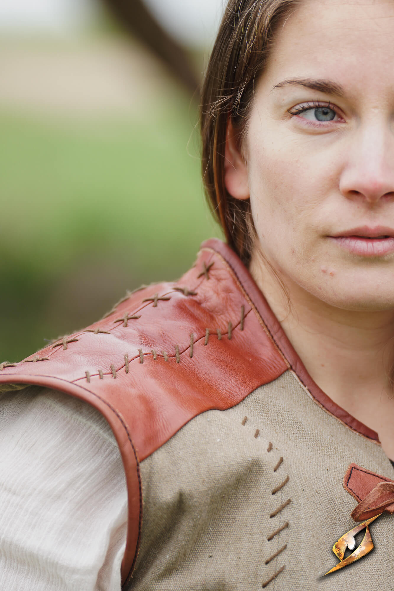 Rugged Canvas Jerkin featuring leather shoulder reinforcement and decorative hand stitching details.