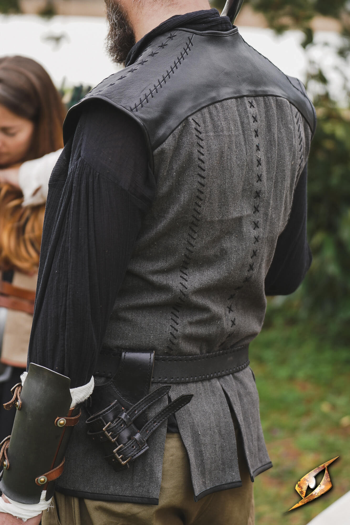 Rugged Canvas Jerkin featuring leather shoulder reinforcement and decorative stitching on the back.