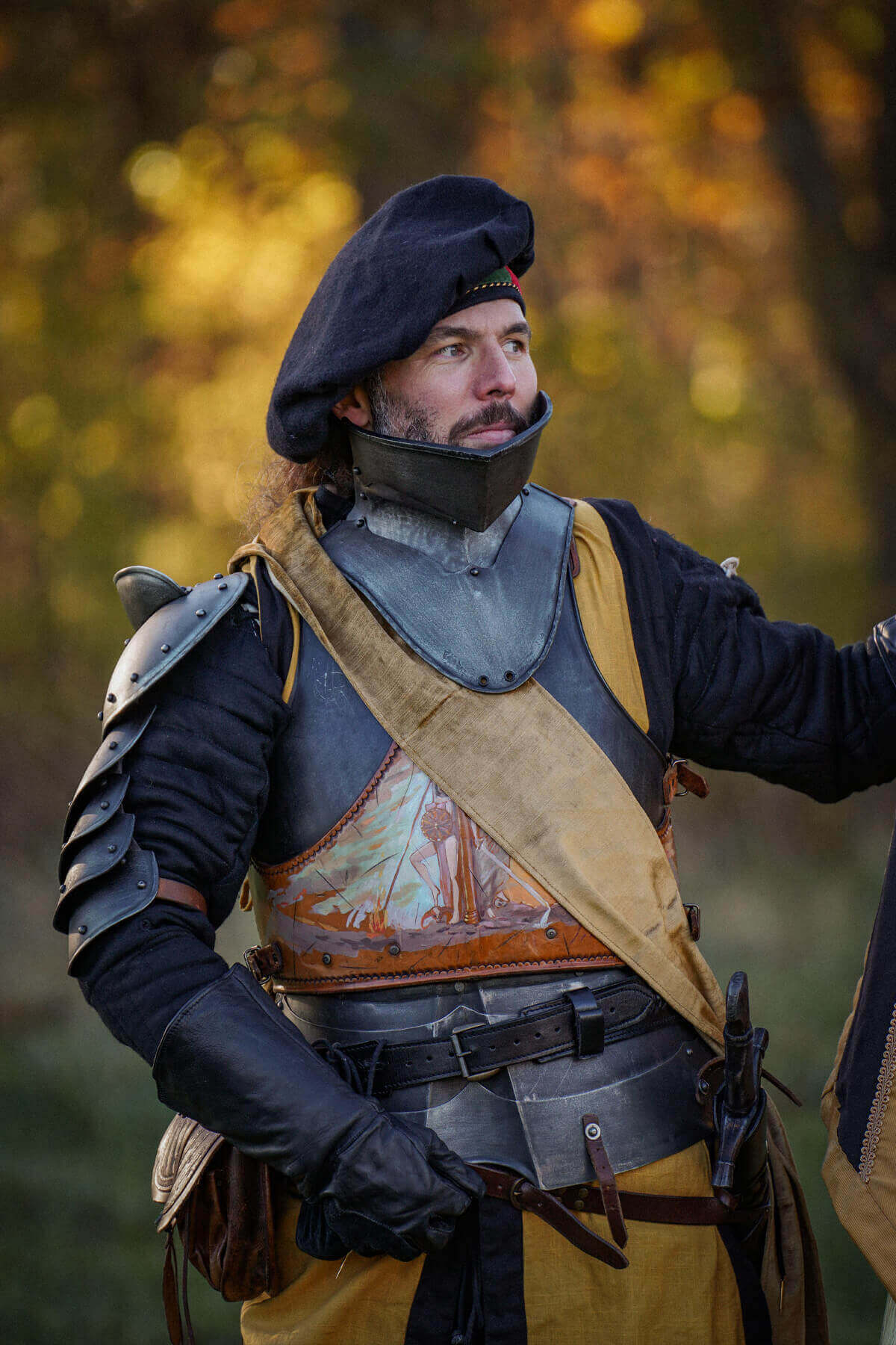 Man in historical armor standing in a forest setting