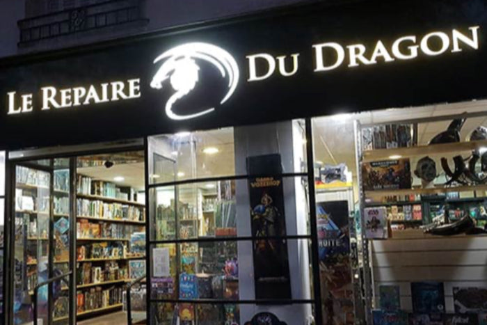 Storefront of Le Repaire Du Dragon, showcasing a variety of board games and collectibles.